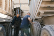 © Ezequiel Giménez/Stocksy - Male mechanic pushing truck wheel
