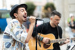 © Alvaro Lavin/Stocksy - musical couple giving a concert in the street