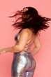 © Valentina Barreto/Stocksy - Woman dancing with silver bright outfit
