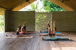 © Mihajlo Ckovric/Stocksy - Group class at yoga retreat center