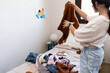 © Eloísa Ramos/Stocksy - Preteen girl sorting clothes at her bedroom