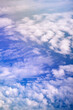 © Ron Mellott/Stocksy - Afternoon cloud patterns from above from inside airplane film