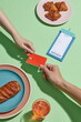 © Marc Tran/Stocksy - Customers give waiter mock up of credit bank card at table