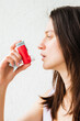 © Asya Molochkova/Stocksy - Using an inhaler during asthma