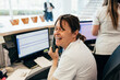 © VICTOR TORRES/Stocksy - Happy nurse talking on telephone during work