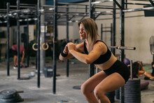 A Woman Performs Resistance Exercise In The Gym.