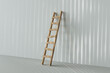 © Giada Canu/Stocksy - wooden ladder on a white wall