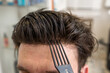 © Alvaro Lavin/Stocksy - bald man with wig being styled in beauty salon