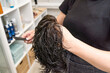 © Alvaro Lavin/Stocksy - woman hairdresser combing and washing hair prosthesis