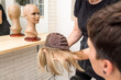 © Alvaro Lavin/Stocksy - woman choosing oncologic wig due to illness