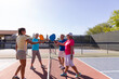 © Raymond Forbes LLC/Stocksy - Pickleball Senior Citizen Touch paddles on court  during match Arizona