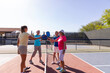 © Raymond Forbes LLC/Stocksy - Senior Citizen Touch paddles on pickleball court competition
