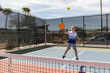 © Raymond Forbes LLC/Stocksy - Young boy Pickleball player looks to swing at ball