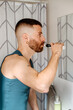 © Lucas Ottone/Stocksy - Modern man brushing his teeth