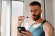 © Lucas Ottone/Stocksy - Modern man brushing his teeth and texting on his phone