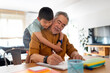 © Santi Nuñez/Stocksy - Elderly Chinese man helps grandson learn.