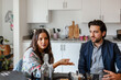 © ByLorena/Stocksy - Business couple during brunch at kitchen office
