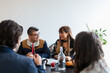 © ByLorena/Stocksy - Professional business team have breakfast at office