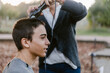 © ByLorena/Stocksy - Happy teenager boy shaving hair outside home