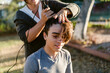 © ByLorena/Stocksy - Teen boy getting buzz cut By mother outdoors
