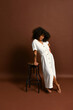 © Javier Díez/Stocksy - Mixed race woman in white dress