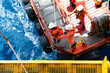 © MR.Zanis - Offshore oil and gas platform during crew boat transfer worker to the platform during sunset time