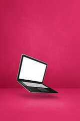 Canvas Print - Floating computer laptop isolated on pink. Vertical background