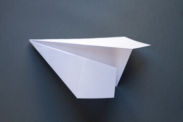 Wall Mural - white paper plane origami isolated on a grey background