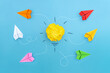 Different vision creative and Innovative solution for Business concepts. Yellow crumpled paper light bulb with paper planes on blue background