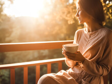 Woman Enjoying A Cup Of Morning Coffee Or Tea On The Porch In Soft Morning Light. Concept Of De-stress, Mindfulness And Weekend Days. Shallow Field Of View, Illustrative Generative AI. 