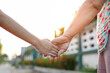 © maeching - parent holds the hand of a small child