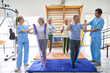 © Robert Kneschke - Therapists with elderly patients exercising at rehab center