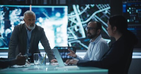 Fototapete - Team of Surveillance Experts Having a Discussion During a Meeting in an Advanced Research Center. Diverse Group of Professionals Monitoring an Active Operation with Satellite Tracking Technology