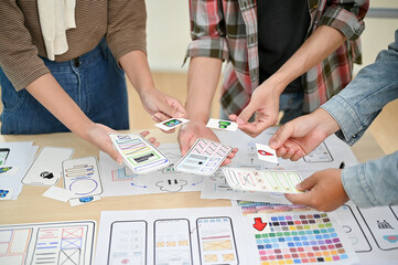 Wall Mural - a close-up image of a team of professional apps developers is in the meeting