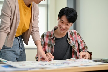 Wall Mural - a male developer enjoys brainstorming on a new prototype for a new app with a female colleague