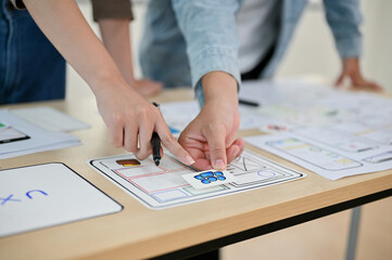 Wall Mural - a close-up image of professional app developers brainstorming, discussing work