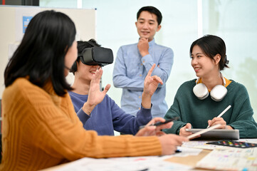 Wall Mural - an excited asian male developer tested a new virtual reality headset with his team