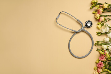 Wall Mural - Stethoscope and flowers on dark beige background, flat lay with space for text. Happy Doctor's Day