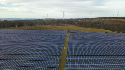 Wall Mural - aerial drone view of a hybrid wind and solar farm for renewable clean energy supply located at banni