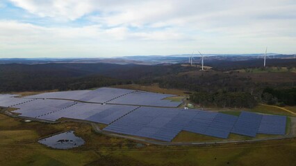 Wall Mural - aerial drone view of a hybrid wind and solar farm for renewable clean energy supply located at banni