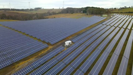 Wall Mural - aerial drone view of a hybrid wind and solar farm for renewable clean energy supply located at banni