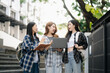© Nuttapong punna - Three young Asian college students and a female student group work at the campus park