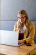 © WavebreakMediaMicro - Happy plus size caucasian casual businesswoman in glasses using laptop at desk