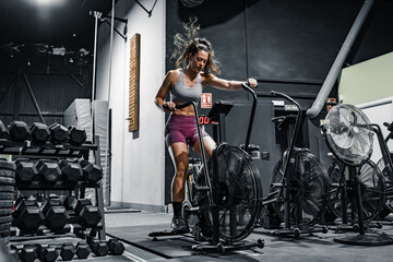 woman doing cardio on the crossfit bike