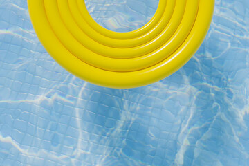 Yellow round donut pool float in a bright blue swimming pool