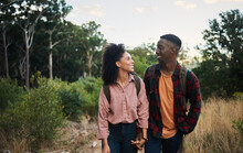 Smiling Young Multiethnic Couple Standing Together During A Trail Hike