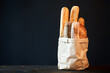 Different types of french bread baguettes in paper bag over dark background with copy space