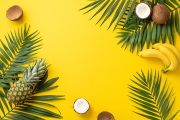 Wall Mural - Embracing summer vacation vibes. Top view of green palm leaves, and juicy tropical fruits, such as coconut, banana, pineapple on a lively yellow backdrop with space for text or promotional material