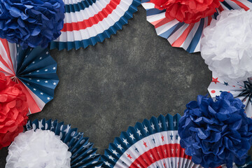 4th of July background. USA paper fans, Red, blue, white stars, balloons, gold confetti on gray dark concrete background. Happy Labor, Independence or Presidents Day. American flag colors. Top view.