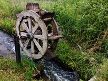 A Wheel That Moves From The Flow Of Water. A Wooden Wheel For A Mill.